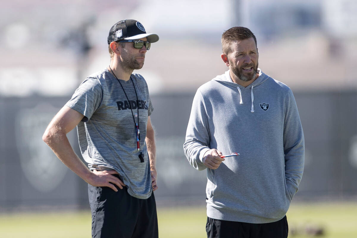 Raiders interim offensive coordinator Bo Hardegree, left, speaks to passing coordinator Scott T ...