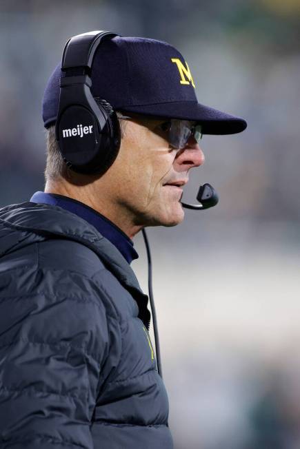 Michigan coach Jim Harbaugh watches during an NCAA college football game against Michigan State ...