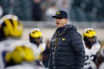 Michigan coach Jim Harbaugh watches during warmups before an NCAA college football game against ...