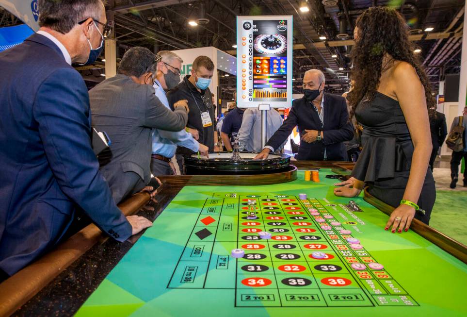 Attendees play a TCSJOHNHUXLEY Roulette wheel during day 2 of the Global Gaming Expo 2021 confe ...