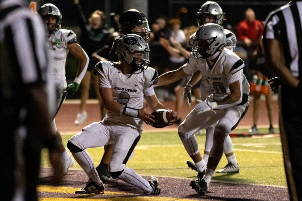 Palo Verde quarterback Crew Dannels (2) is congratulated on his touchdown by Cedric Cade Jr. (1 ...