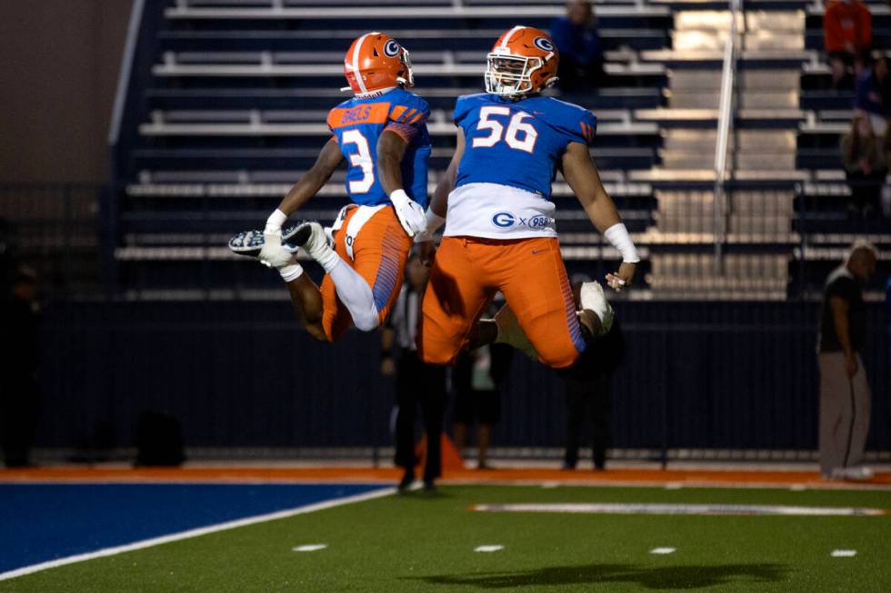 Bishop Gorman running back Devon Rice (3) and offensive lineman Doug Utu (56) celebrate Rice&#x ...