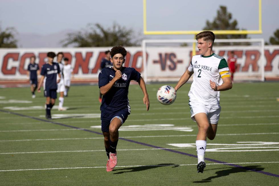 Coronado striker Dylan Flores, left, sprints for the ball against Palo Verde defender Preston M ...