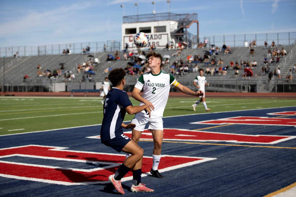 Palo Verde defender Preston Mendenhall (2) heads the ball away from the net after Coronado stri ...