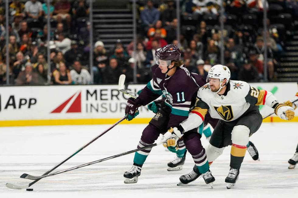 Anaheim Ducks center Trevor Zegras, left, and Vegas Golden Knights defenseman Shea Theodore vie ...