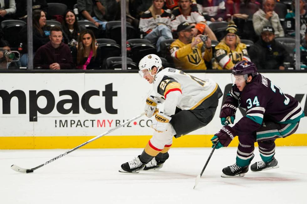 Vegas Golden Knights center Brett Howden, left, controls the puck ahead of Anaheim Ducks defens ...