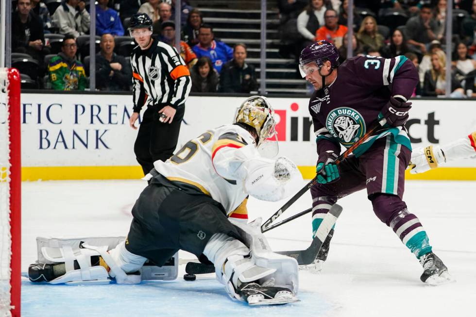 Anaheim Ducks center Sam Carrick, right, scores against Vegas Golden Knights goaltender Logan T ...