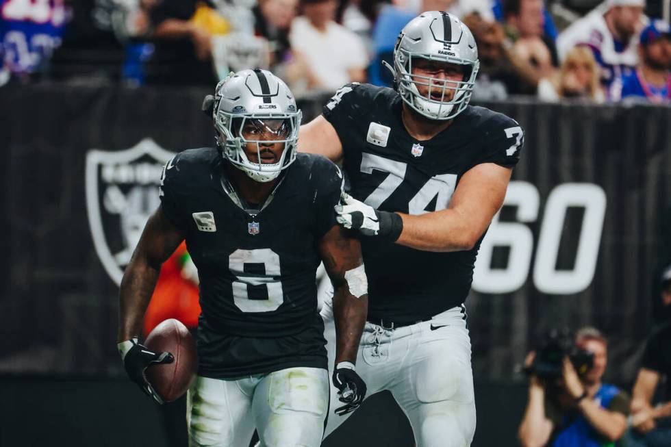 Raiders running back Josh Jacobs (8) and offensive tackle Kolton Miller (74) celebrate Jacob&#x ...