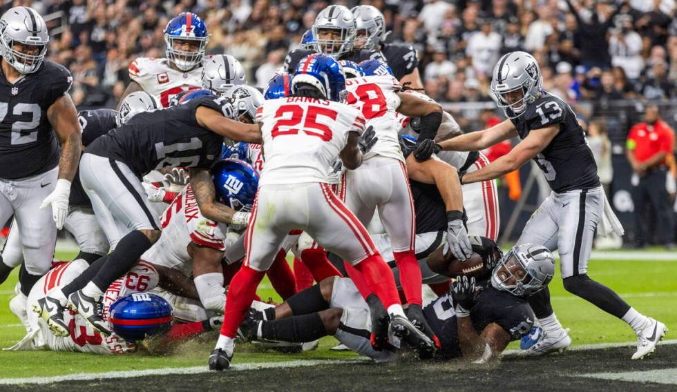 Vegas Raiders running back Josh Jacobs (8) scores against the New York Giants during the first ...