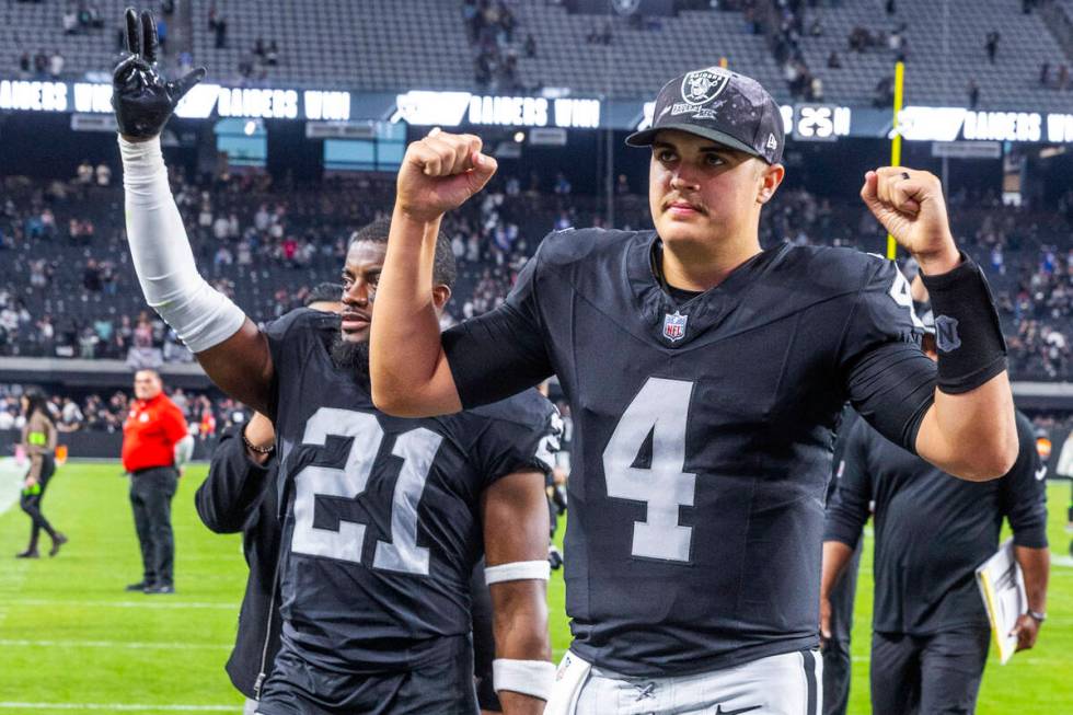 Vegas Raiders quarterback Aidan O'Connell (4) and cornerback Amik Robertson (21) greet fans as ...