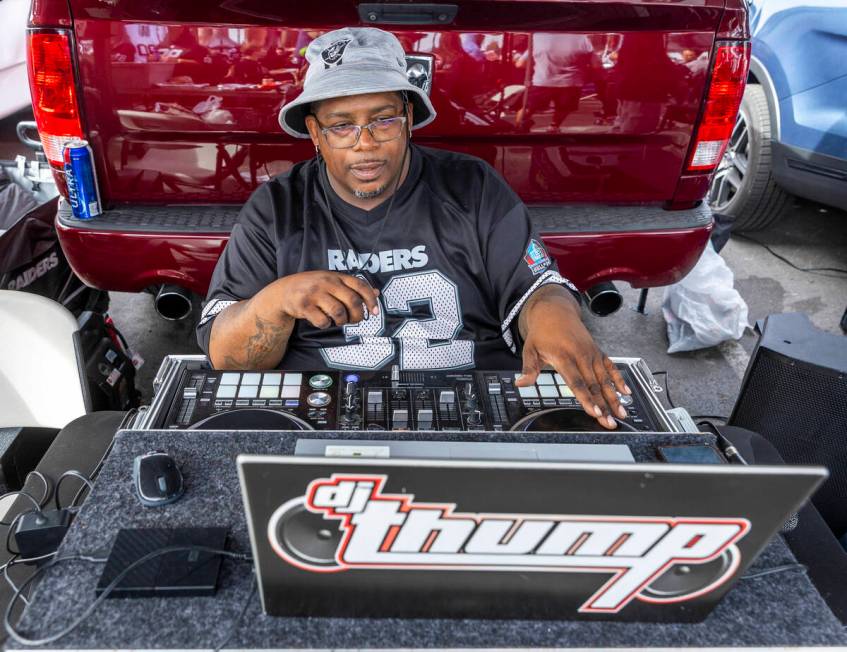 Raiders fan dj thump performs in the tailgating area before the start of the Raiders against th ...