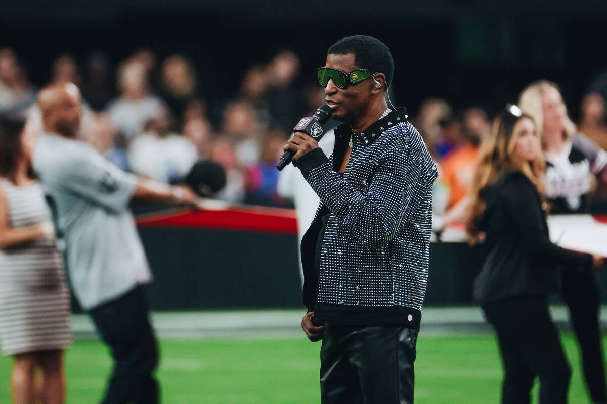 Babyface sings the national anthem before a game between the Raiders and New York Giants at All ...