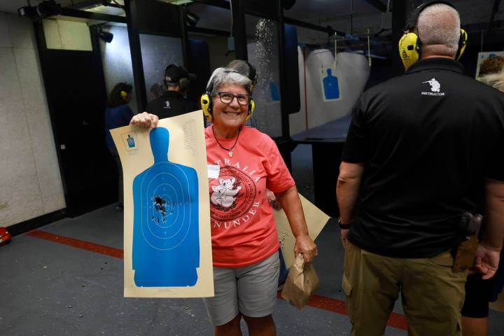 Sandi Lazar, who is Jewish, shows off her target during an introduction to handguns course at t ...