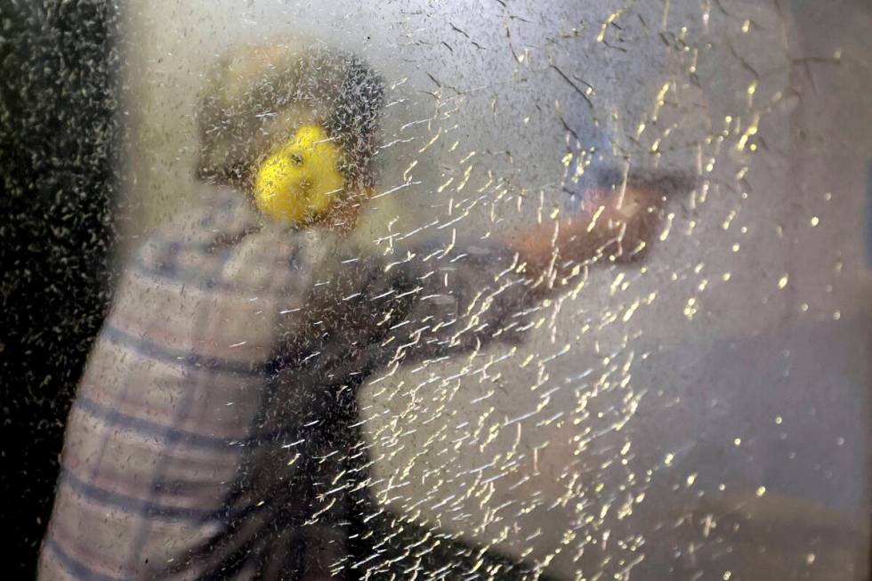 Peter, who is Jewish, fires his gun during an introduction to handguns course at the Gun World ...