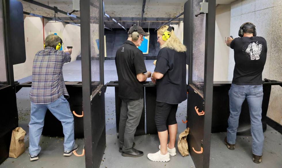 Firearms instructor Bob Pruitt talks with student Jackie Rubin, a former orthodox Jew who conve ...