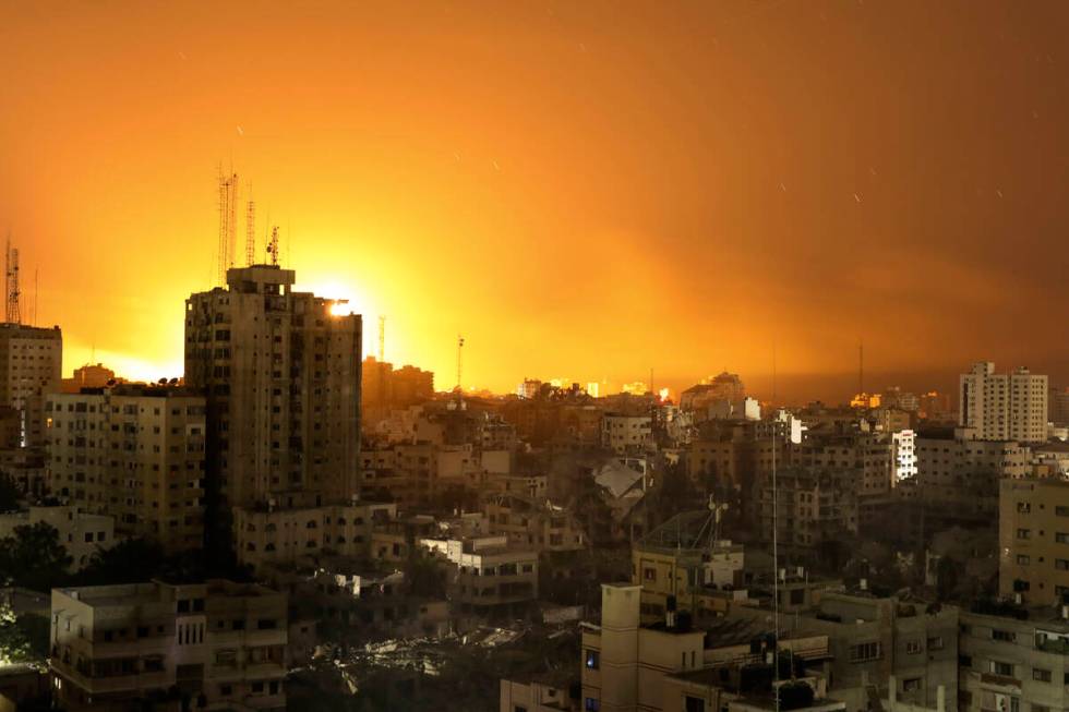 Fire and smoke rises from buildings following Israeli airstrikes on Gaza City, Sunday, Nov. 5, ...