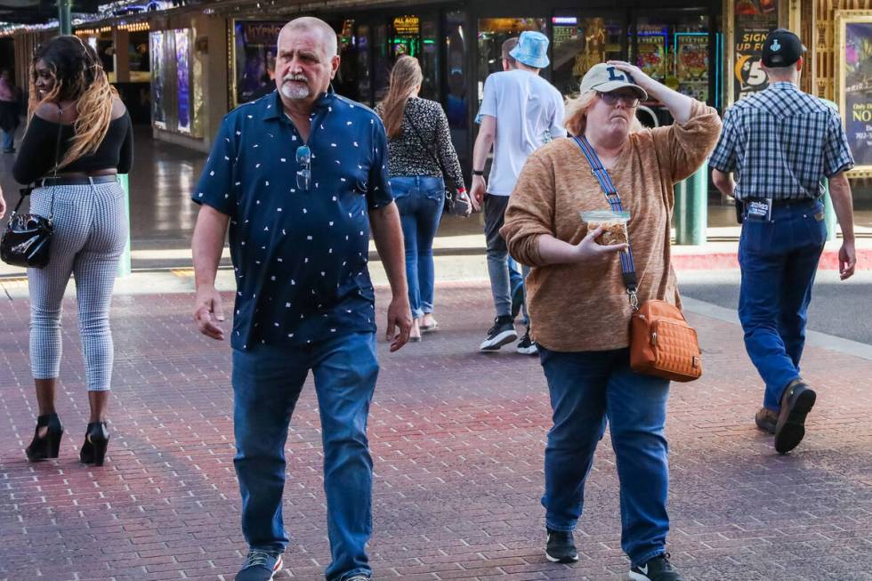 Tourists battle through the wind along Fremont Street on Monday, Nov. 6, 2023 in Las Vegas. (Da ...