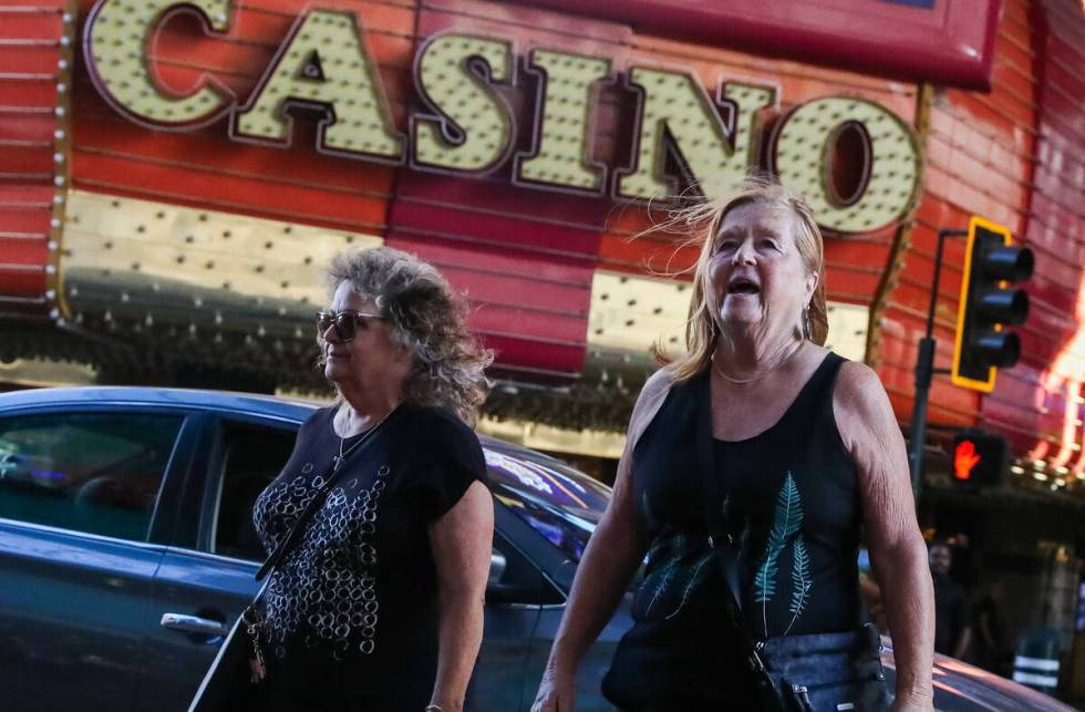 Tourists battle through the wind along Fremont Street on Monday, Nov. 6, 2023 in Las Vegas. (Da ...