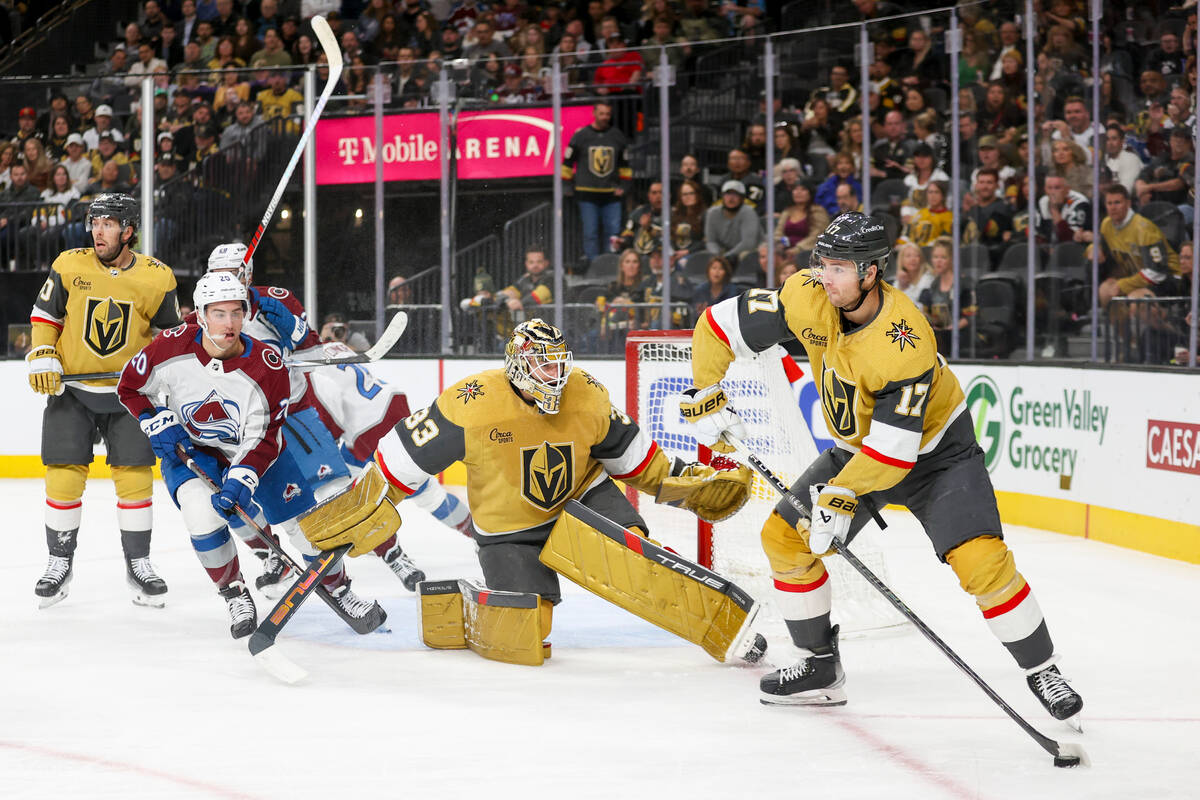 Colorado Avalanche center Ross Colton (20) and Vegas Golden Knights goaltender Adin Hill (33) l ...