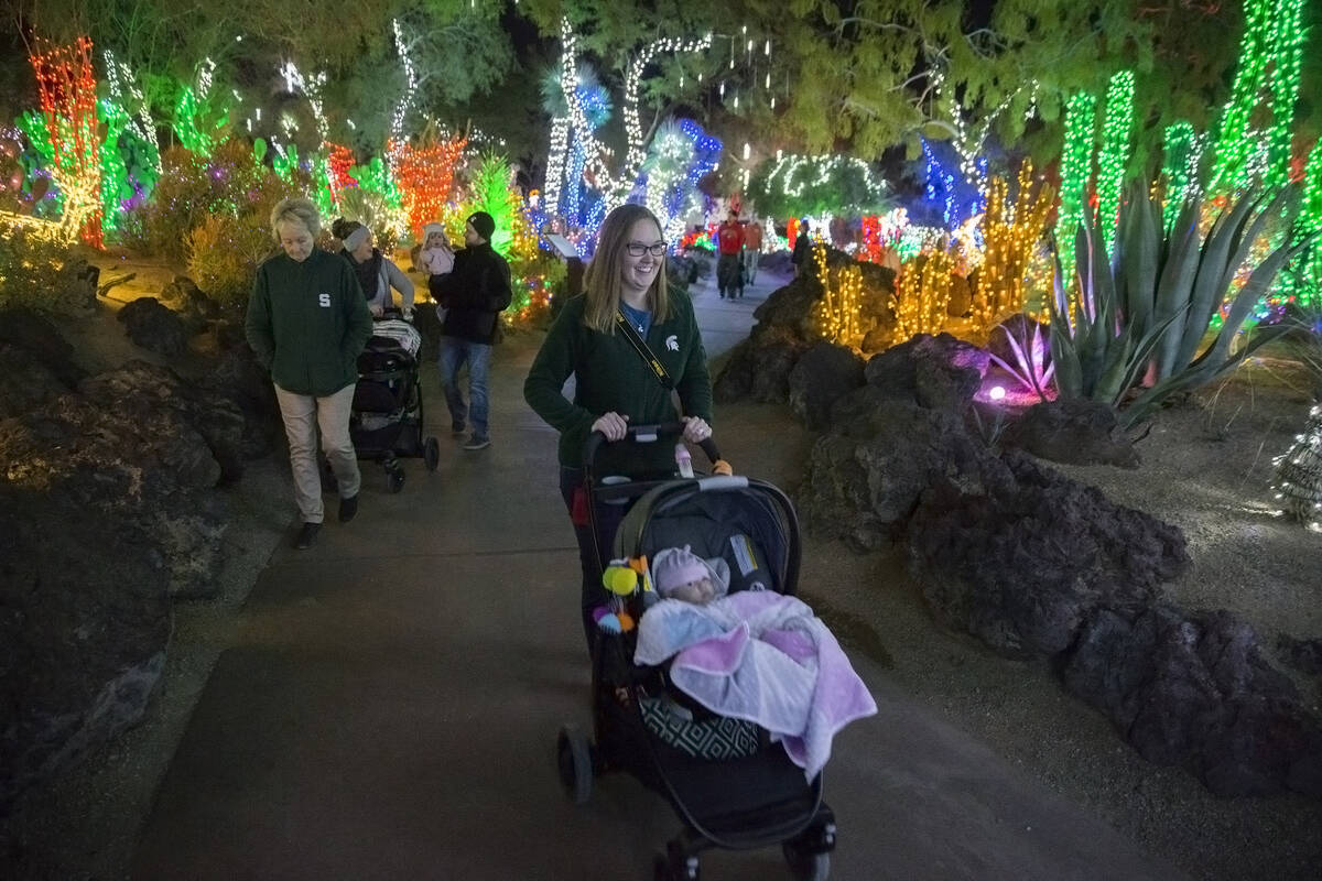 Katie Conklin, middle, pushes her 3-month-old daughter Harper around Ethel M Chocolates Botanic ...