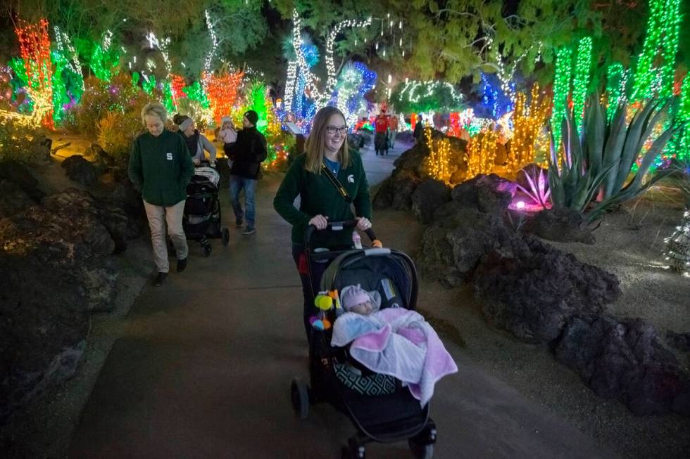 Katie Conklin, middle, pushes her 3-month-old daughter Harper around Ethel M Chocolates Botanic ...