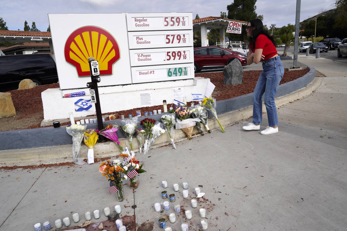 A makeshift shrine is placed at the scene of a Sunday confrontation that lead to death of a dem ...