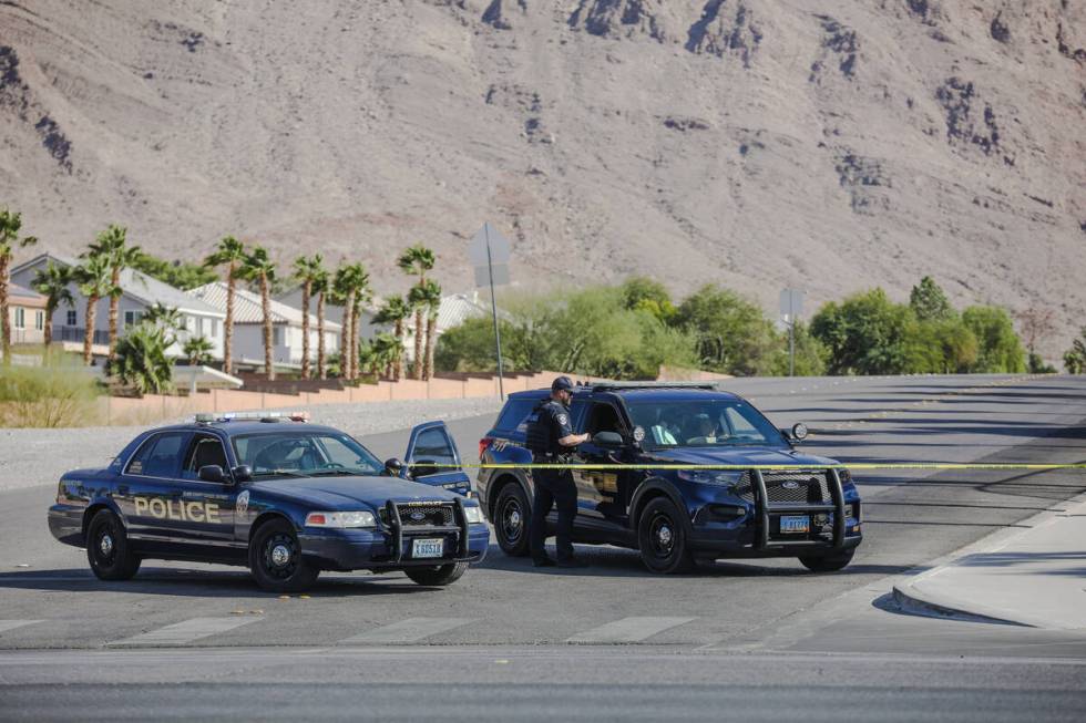 Police guard the entrance to shared-use athletic fields between Harney Middle School and the Ho ...