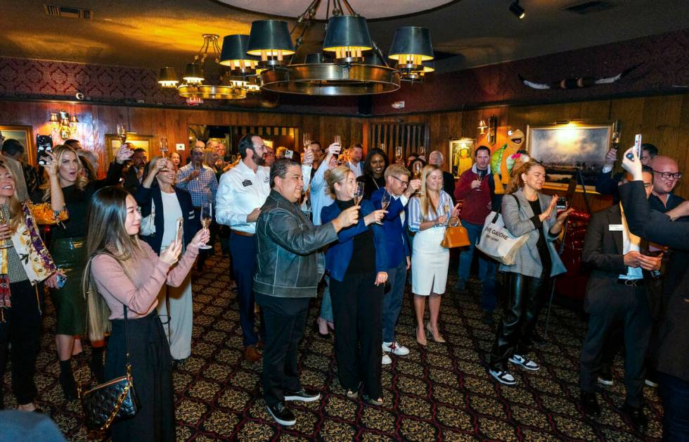 Guests share a toast during an event to celebrate the first expansion in nearly 50 years at the ...