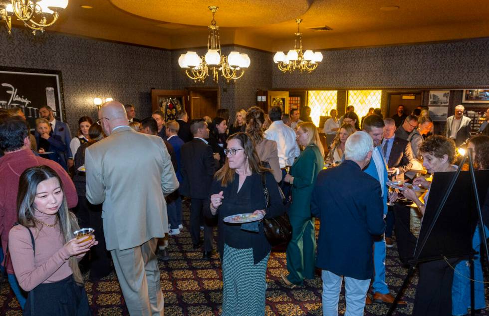 Guests enjoy food and drink in a new room following a ribbon cutting at an event to celebrate t ...