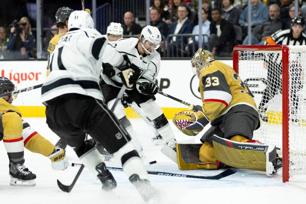 Golden Knights goaltender Adin Hill (33) saves the puck against Kings center Adrian Kempe (9) d ...