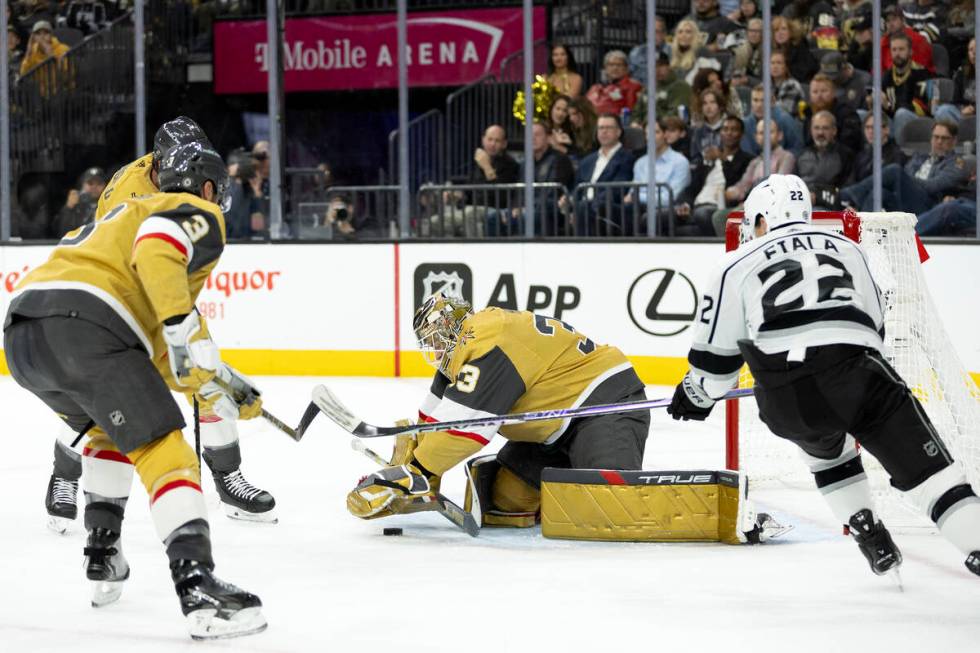 Golden Knights goaltender Adin Hill (33) saves the puck after Kings left wing Kevin Fiala (22) ...