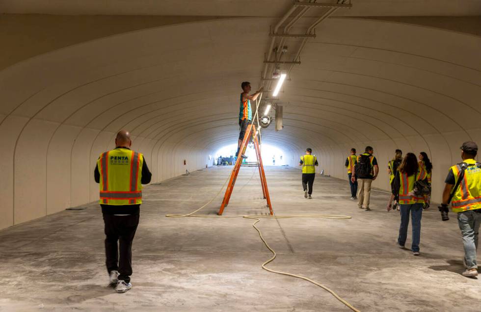 Light panels are hung within one of several tunnels beneath the track as construction continues ...