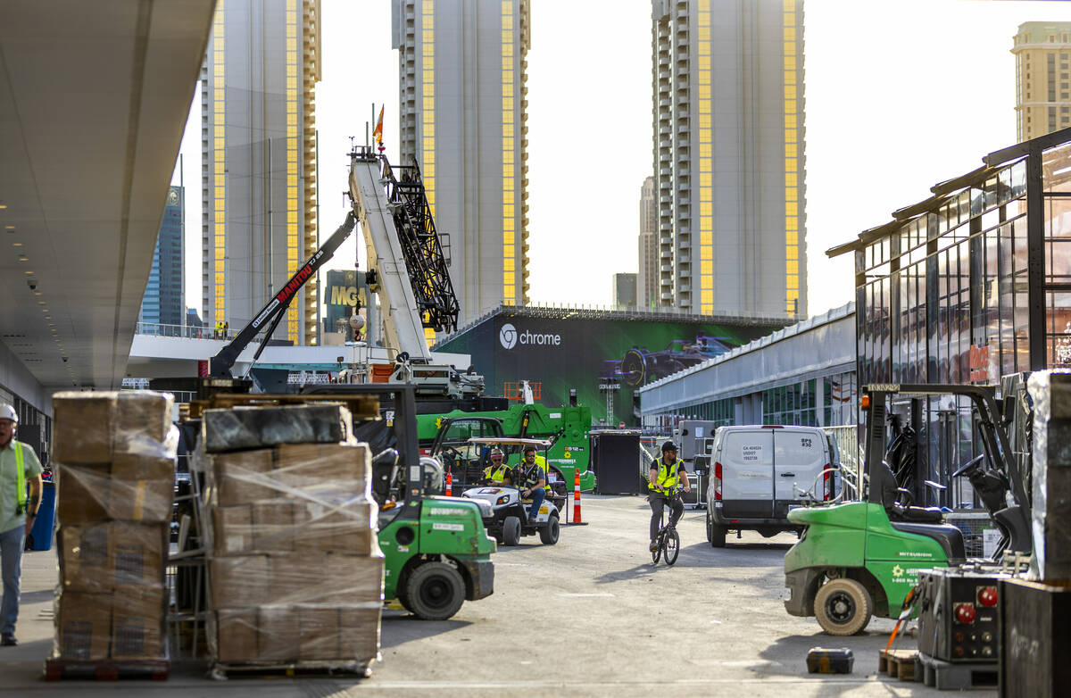 Construction crews moves materials outside team garages at the Formula One Las Vegas Grand Prix ...