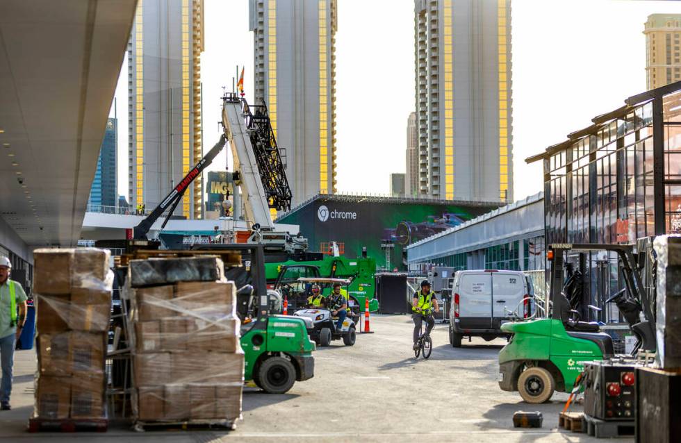Construction crews moves materials outside team garages at the Formula One Las Vegas Grand Prix ...