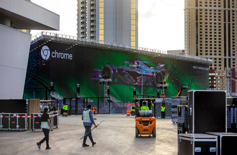 Construction crews moves materials outside team garages at the Formula One Las Vegas Grand Prix ...