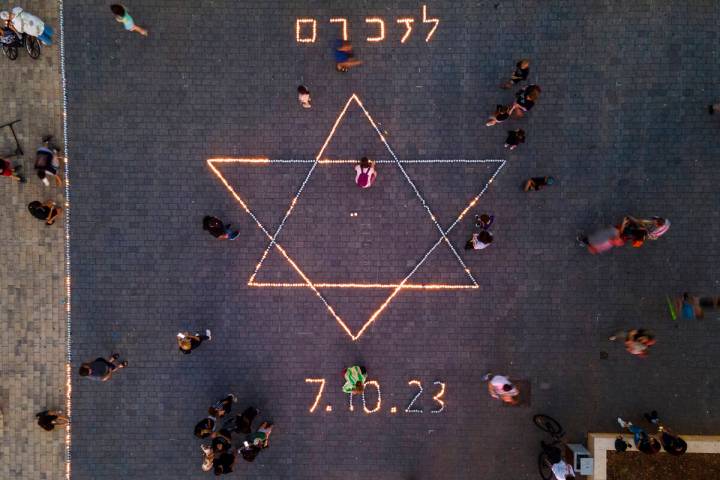 Israelis light candles in memory of the victims the Oct. 7 Hamas bloody cross-border attack in ...