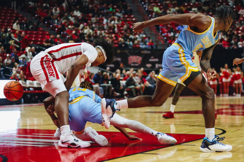 UNLV forward Rob Whaley Jr. (5) fights to keep Southern guard Brandon Davis (10) away after los ...