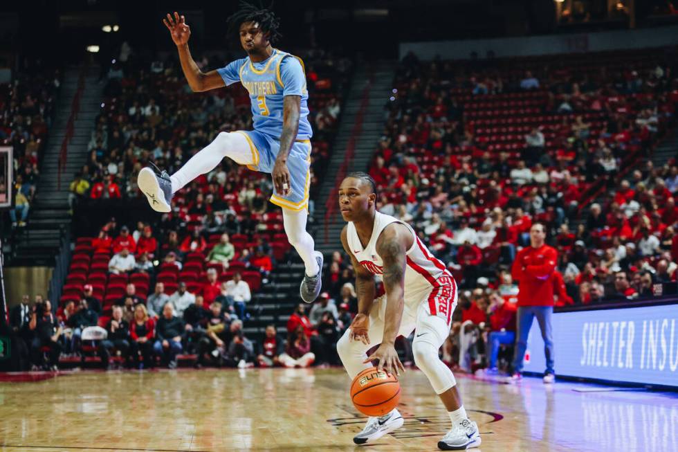 Southern guard Tai'Reon Joseph (3) jumps into the air as UNLV guard Jackie Johnson III (24) dri ...