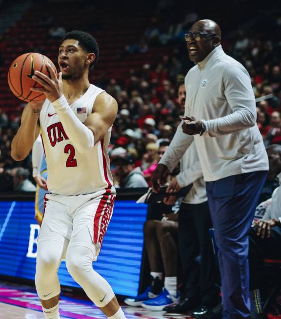 Southern head coach Kevin Johnson screams to his team as UNLV guard Justin Webster (2) looks to ...