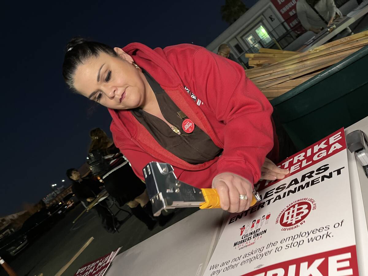 Culinary Local 226 member Mercie Gonzalez prepares strike signs at the union's headquarters on ...