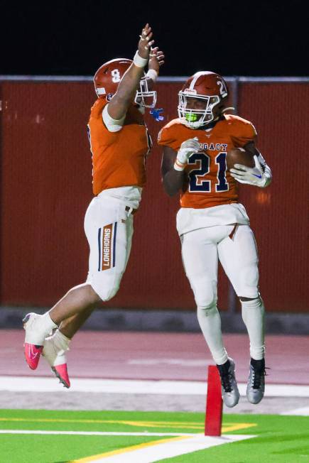 Legacy’s Aidan Crawford (9) congratulates Legacy’s Airamis Craven (21) for making ...