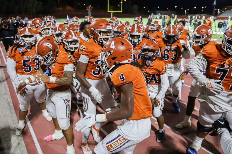 Legacy High School football players celebrate winning the Class 5A Division III Southern League ...