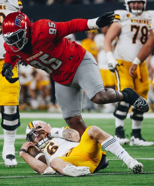 UNLV defensive lineman Alexander Whitmore (95) celebrates taking down Wyoming quarterback Andre ...