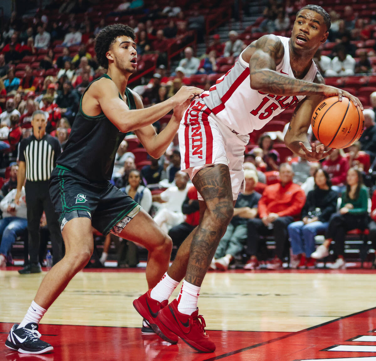 UNLV guard Luis Rodriguez (15) tries to stay in bounds as he looks to pass the ball to a teamma ...