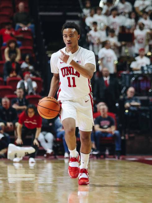 UNLV guard Dedan Thomas Jr. (11) signals to a teammate as he dribbles the ball down the court d ...