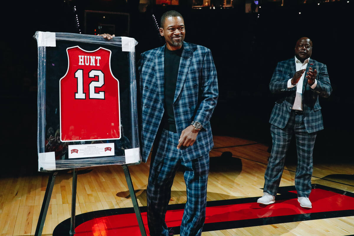 Anderson Hunt poses with his jersey during a jersey retirement ceremony during a game between U ...