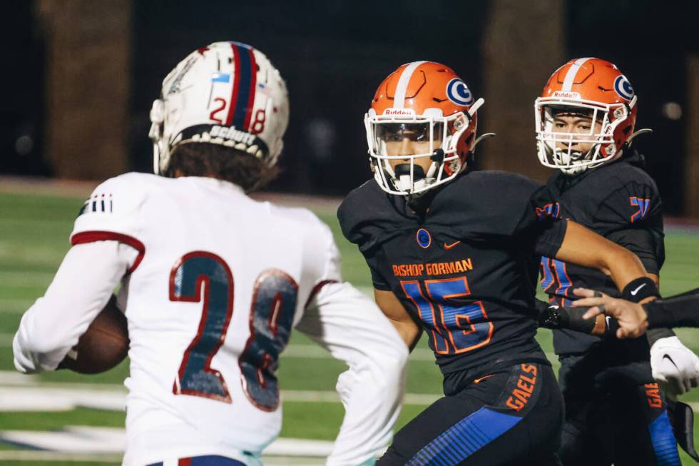 Bishop Gorman defensive back Justin Colin (16) comes running at Liberty running back Yasir Mose ...