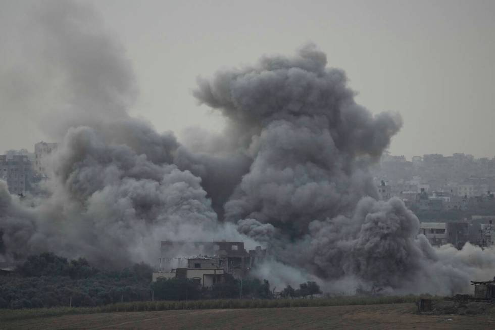 Smoke rises following an Israeli airstrike in the Gaza Strip, as seen from southern Israel, Sun ...