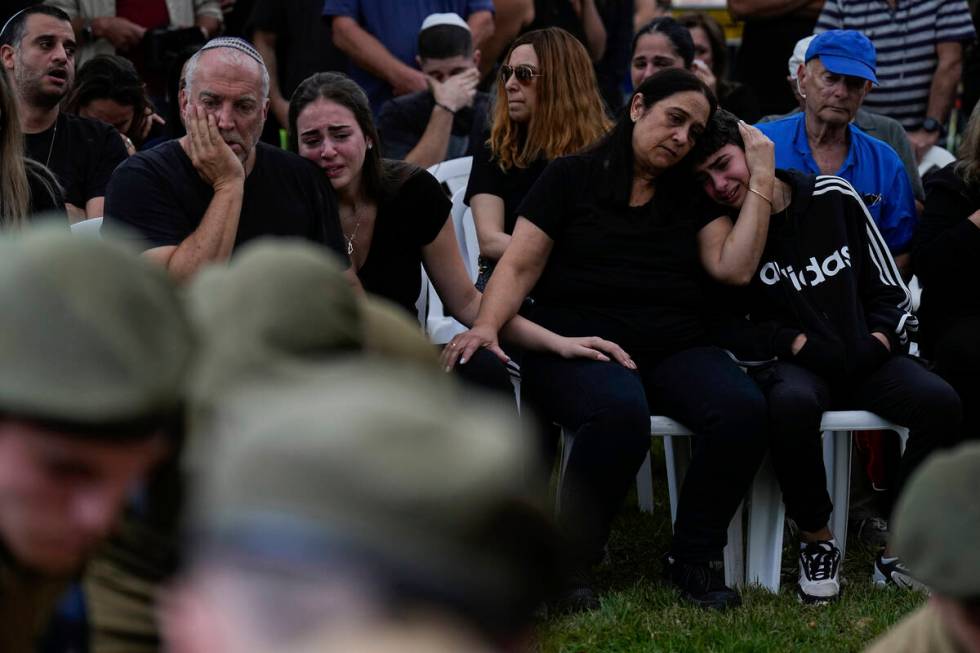 Family members of Sgt. Roni Eshel cry during her funeral in Kfar Saba, Israel, Sunday Nov. 12, ...