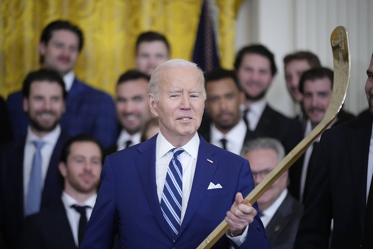 President Joe Biden speaks while holding a hockey stick during an event to celebrate the Vegas ...